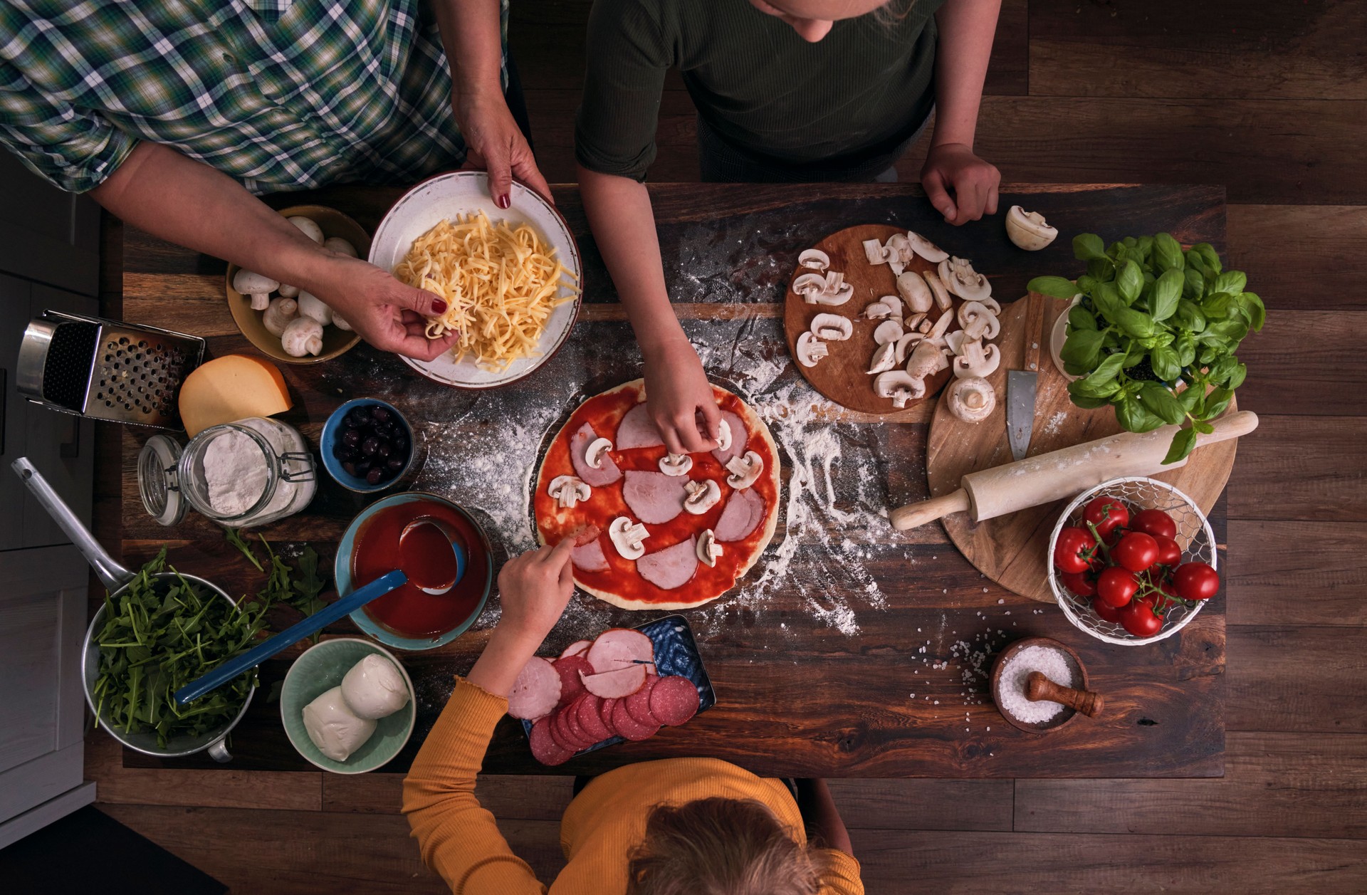 Kids Preparing Pizza with their Mum at Home in Domestic Kitchen
